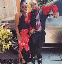 a man and a woman standing next to a car